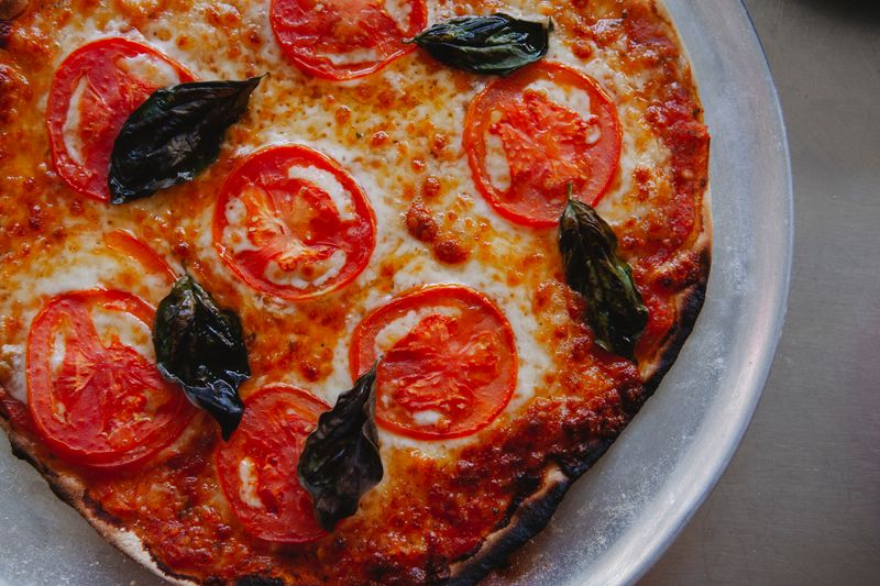 Vegetarian garden pizza with fresh toppings on thin crust