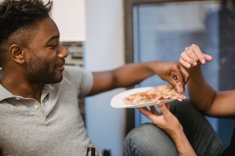 Friends enjoying crust pizza delivered to their home in Australia